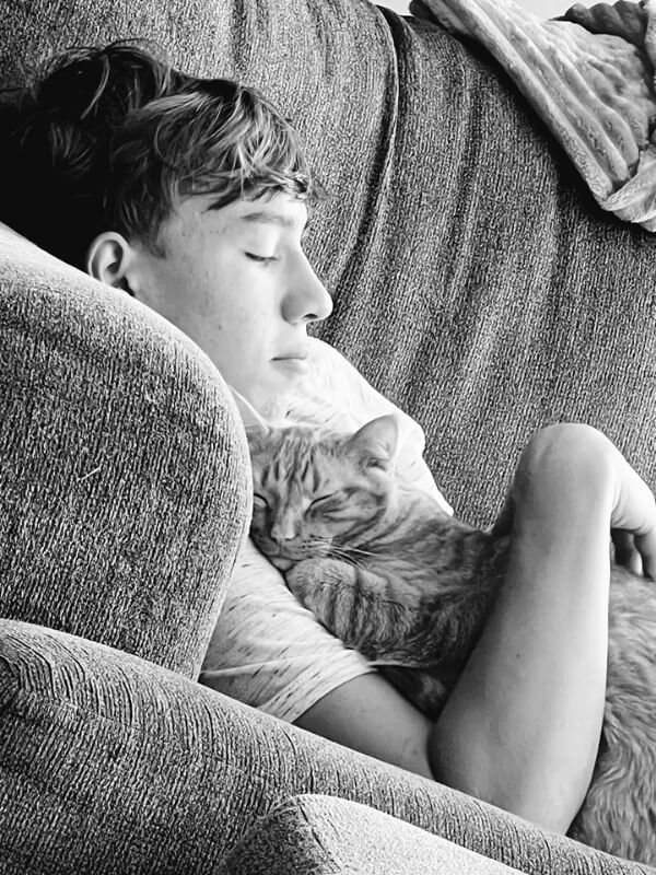 Boy Napping On Couch With Cat