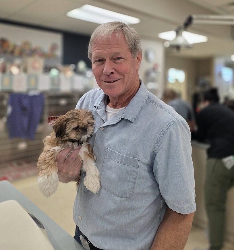 Dr. Dave Kroeger - male veterinarian holding a Shih Tzu